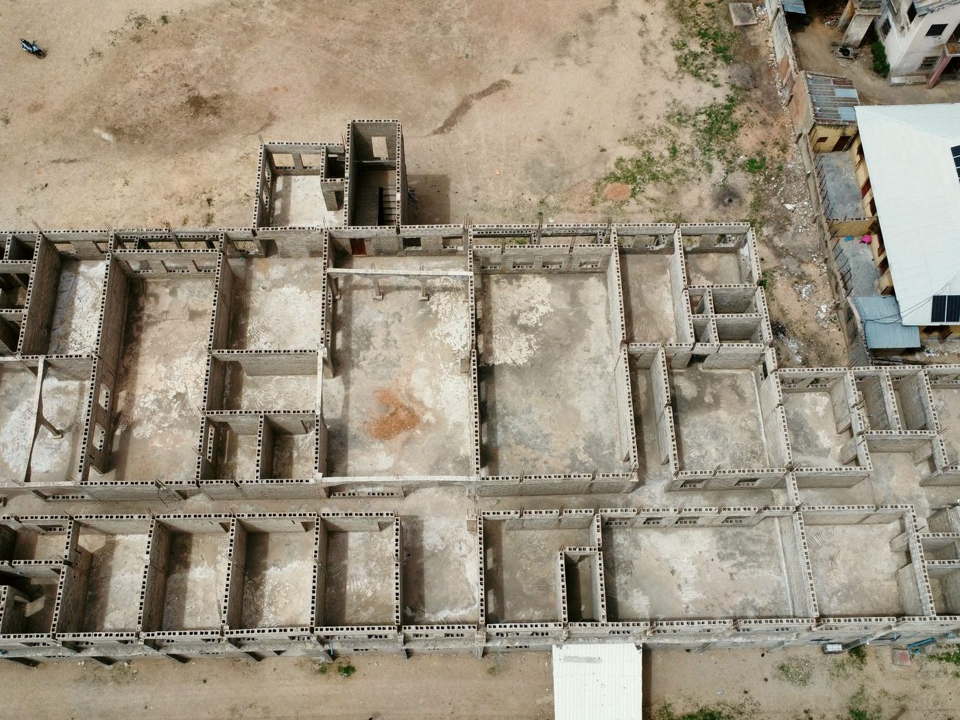 Aerial view of a building under construction on cleared ground in Nigeria.